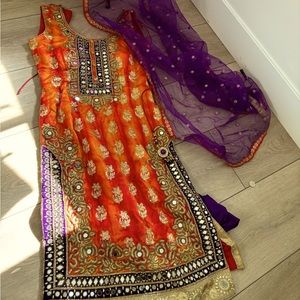 Beautiful orange and purple heavy embroidered mirror work Indian outfit.